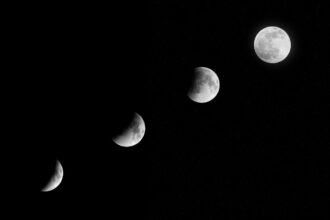 A partial lunar eclipse visible in the early morning sky over Germany